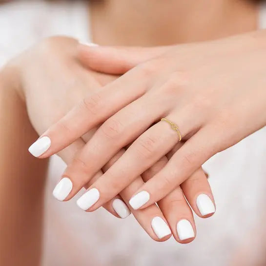 14K yellow gold polished open heart ring worn on hand showing its delicate size and slim band