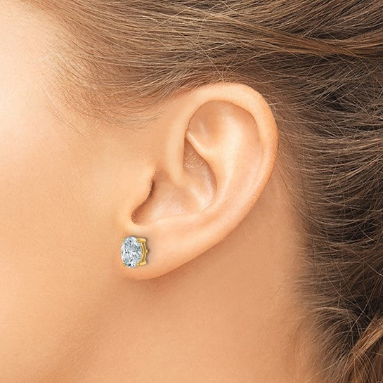 Oval lab grown diamond stud earring in a 14K yellow gold four-prong setting, shown worn on an ear.