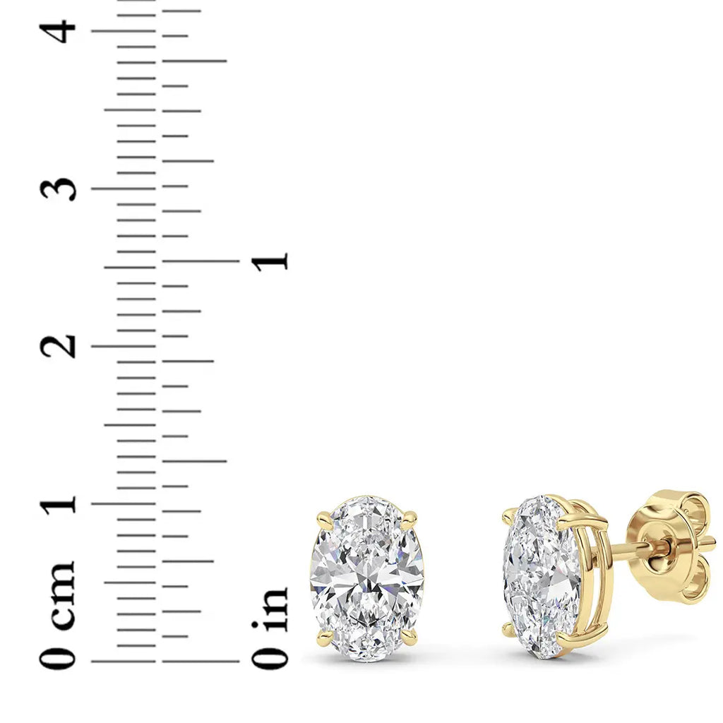 14K yellow gold 4 ct oval lab grown diamond stud earrings shown beside ruler for size reference