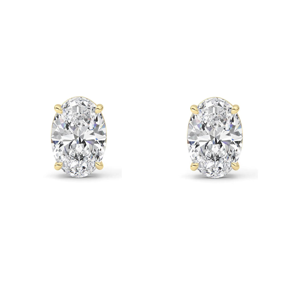 Pair of 4 ct IGI certified oval lab grown diamond stud earrings in 14K yellow gold on white background
