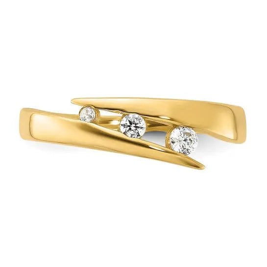 A yellow gold ring with three round-cut clear gemstones set in a curved, layered design, shown on a plain white background.