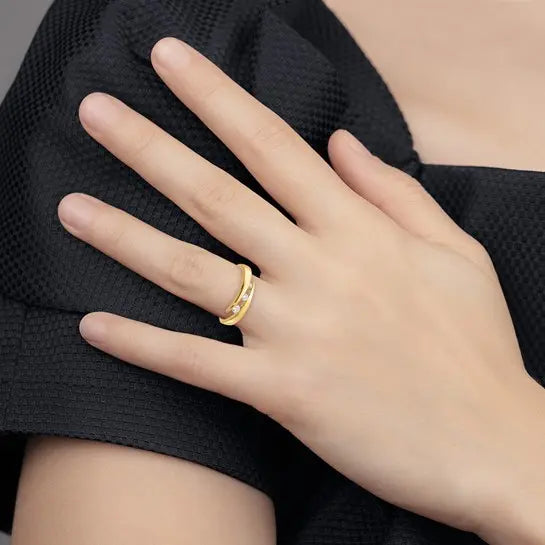 14K yellow gold graduated 3-stone CZ bypass ring worn on hand showing delicate scale and everyday fit