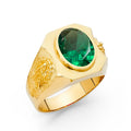 14K yellow gold men's wide statement ring with bezel-set oval green CZ center stone and engraved Virgin Mary shoulder detail on white background