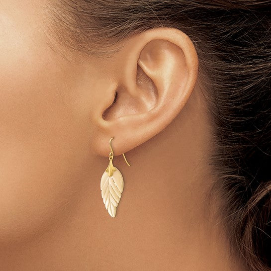 14K yellow gold mother of pearl leaf dangle earring worn on ear showing scale and French hook