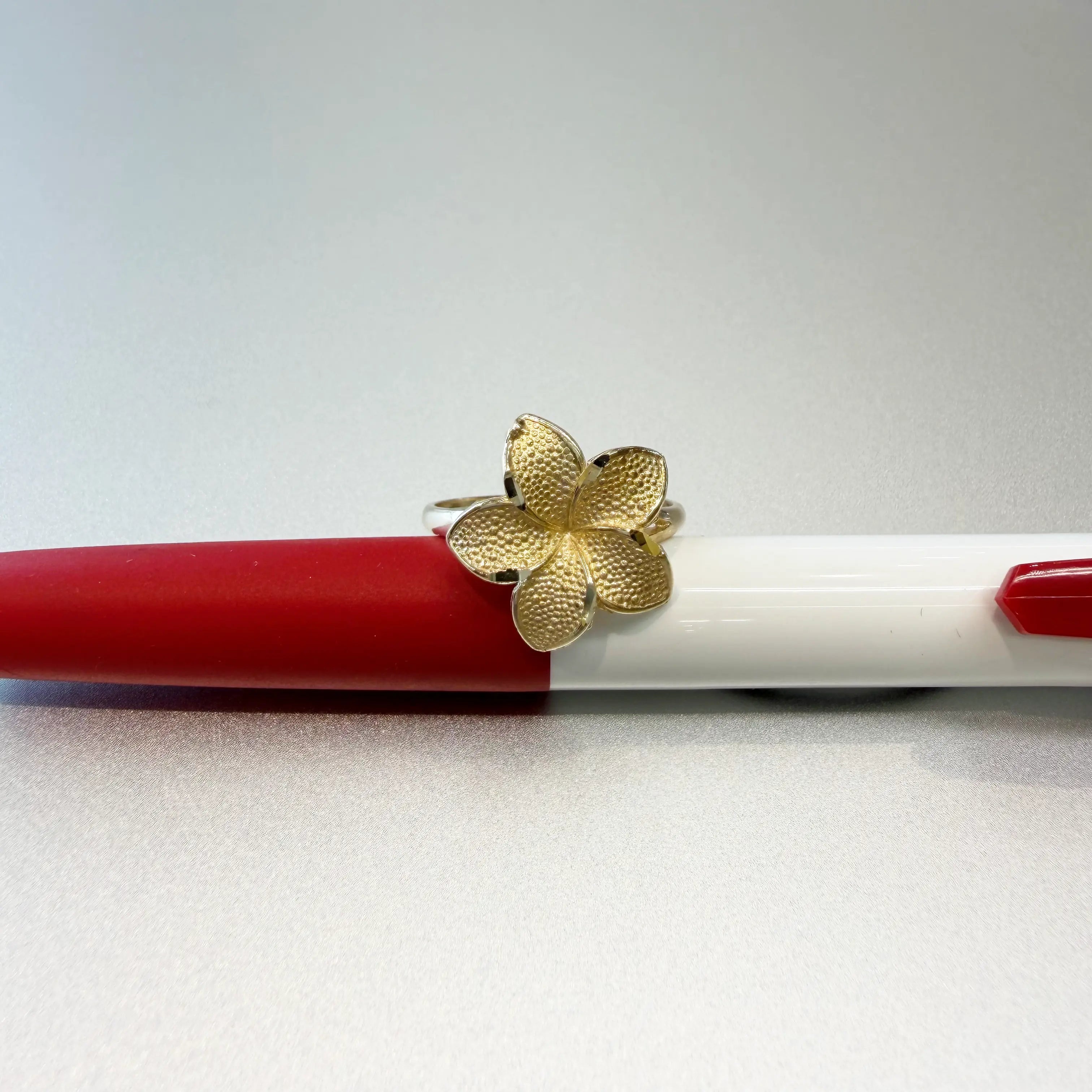 14K yellow gold plumeria flower ring large size with beaded petal texture and split shank band on white background